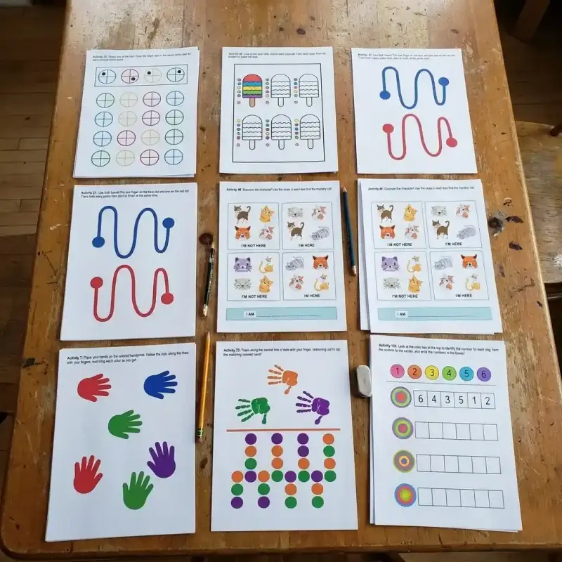 Printed MindKids activity sheets laid out on a table