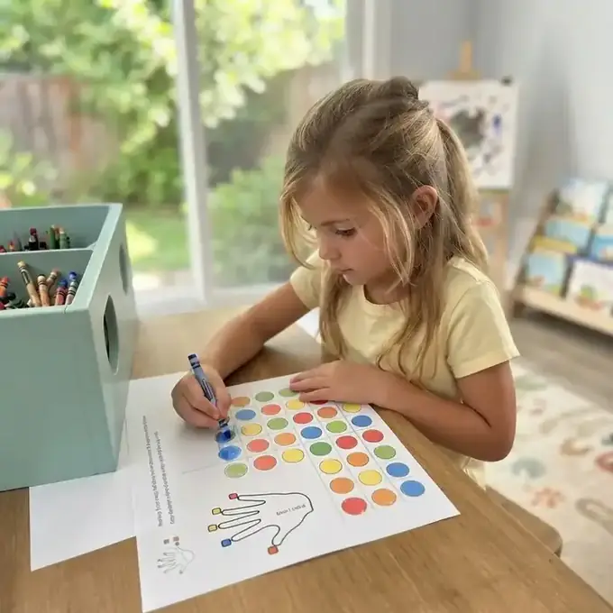 Child completing a MindKids color matching printable activity